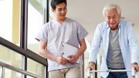 Senior patient talking to physical therapist